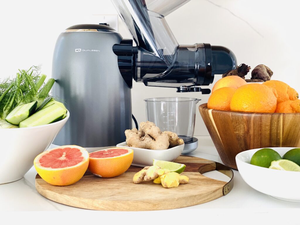 closeup of juicer, fruits, and vegetables in bowls 2