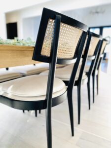 closeup black chair with white seating and rattan back