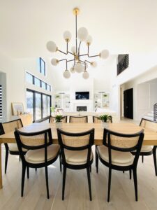 dining table with black chairs and a black chandelier