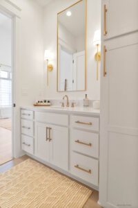 white and gold bathroom cupboard and mirror