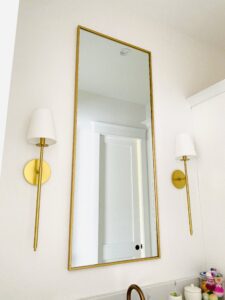 gold rectangular mirror with gold tipped lamps