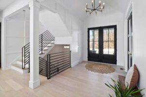 hallway with staircase and room with balcony